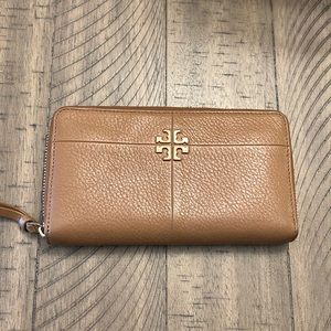 Slightly used but in good condition TB wallet that is 4 1/2 x 8 inches in size.